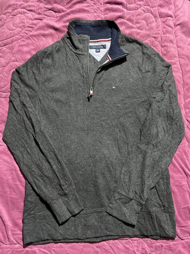 Tommy Hilfiger Grey Quarter Zip Sweatshirt (Category: Coats, Jackets and Outerwear) located in Tagoloan. Submitted by rainebutro69475 (Listing ID 1463913986, Image 2). Description: - Grey Tommy Hilfiger sweatshirt - Quarter zip with navy collar - Small Tommy Hilfiger flag logo on chest - Made in Vietnam - Material: 69% Cotton, 29% Viscose - Size: XS.