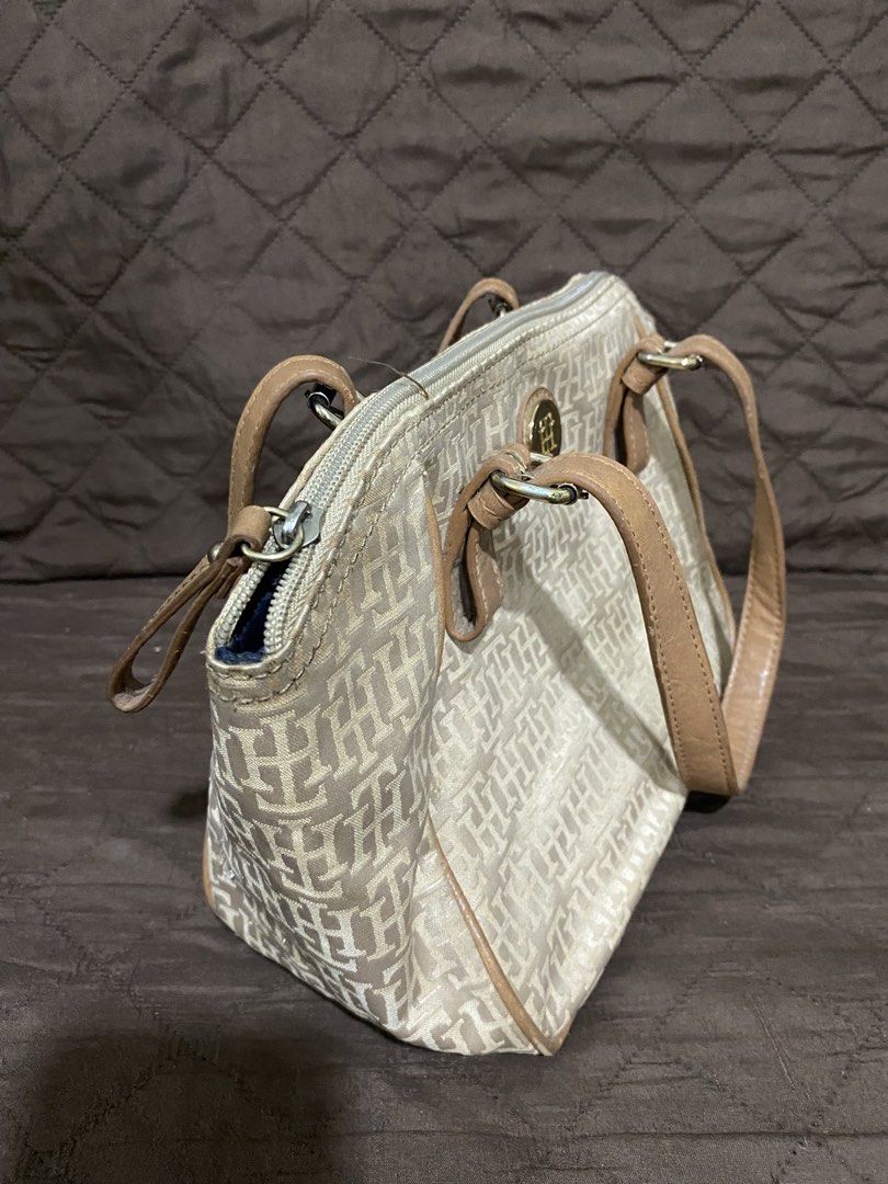Tommy Hilfiger Monogram Canvas & Leather Trimmed Handbag (Category: Luxury Bags & Wallets) located in Manila. Submitted by divinemercy_29 (Listing ID 1463795021, Image 3). Description: - Authentic Tommy Hilfiger monogram canvas handbag - Stylish tan leather trim and handles - Secure zipper closure - Interior features one zippered pocket and two slip pockets - Spacious and ideal for everyday essentials.