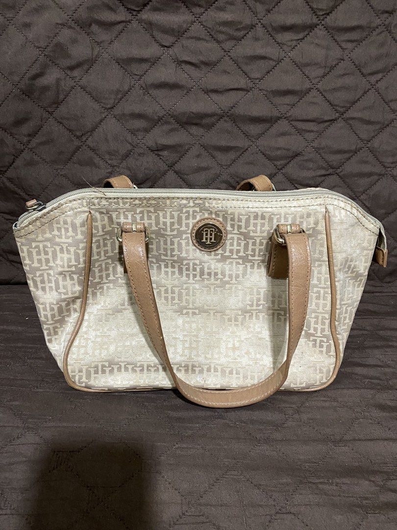 Tommy Hilfiger Monogram Canvas & Leather Trimmed Handbag (Category: Luxury Bags & Wallets) located in Manila. Submitted by divinemercy_29 (Listing ID 1463795021, Image 1). Description: - Authentic Tommy Hilfiger monogram canvas handbag - Stylish tan leather trim and handles - Secure zipper closure - Interior features one zippered pocket and two slip pockets - Spacious and ideal for everyday essentials.