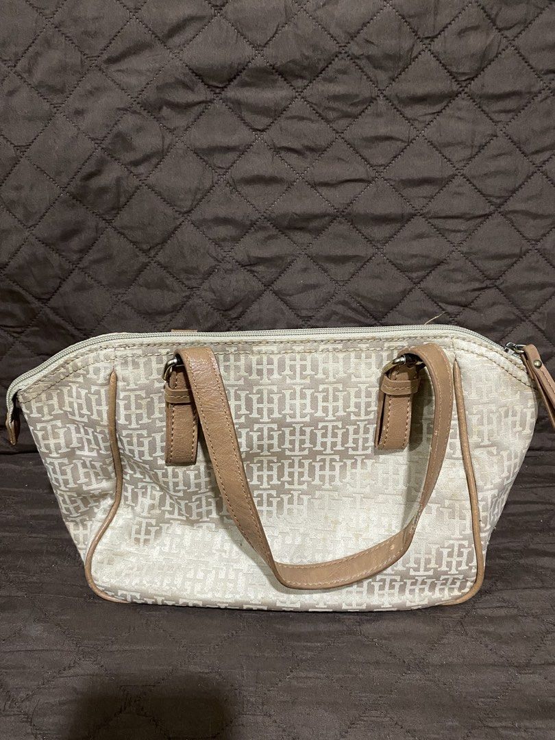 Tommy Hilfiger Monogram Canvas & Leather Trimmed Handbag (Category: Luxury Bags & Wallets) located in Manila. Submitted by divinemercy_29 (Listing ID 1463795021, Image 2). Description: - Authentic Tommy Hilfiger monogram canvas handbag - Stylish tan leather trim and handles - Secure zipper closure - Interior features one zippered pocket and two slip pockets - Spacious and ideal for everyday essentials.