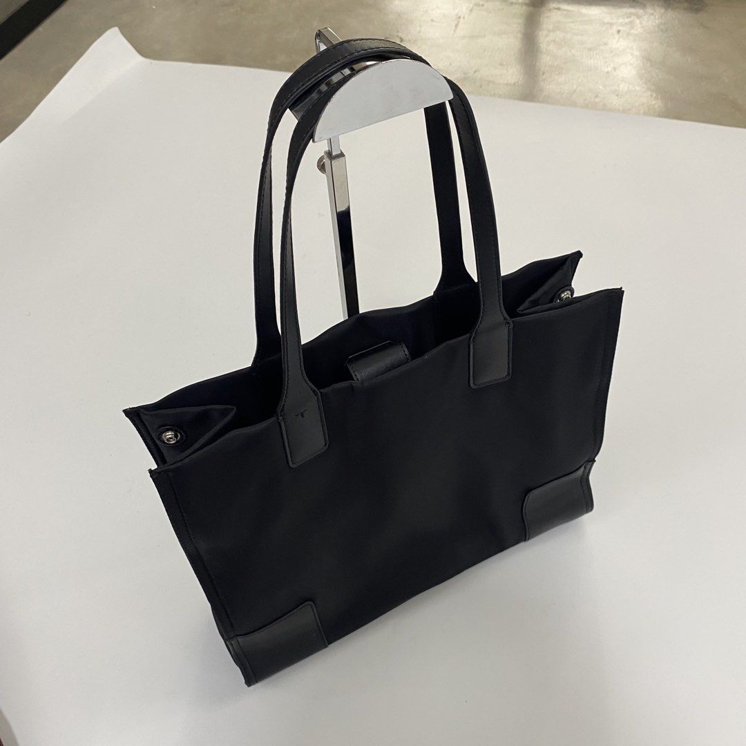 Tory Burch Black Nylon Tote Bag (Category: Tote Bags) located in Manila. Submitted by eddjohn (Listing ID 1463891329, Image 2). Description: - Classic black Tory Burch tote bag - Durable nylon with leather trim - Iconic Double T logo on the front - Spacious interior for essentials - Secure snap closure on top - Interior zip pocket for valuables - Ideal for daily use or travel.