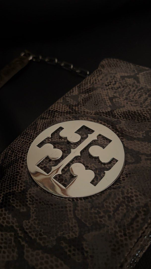 Tory Burch Reva Python Clutch (Category: Luxury Bags & Wallets) located in Davao. Submitted by _iconculture (Listing ID 1463761838, Image 3). Description: AVAILABLE Tory Burch Reva Python Clutch — ₱3,950 H: 6in W: 11in *Rank A Condition (very good) *Chain strap is detachable! *Hairline scratches only metal only *Comes w Generic dustbag More photos DM 🩵 — Not affiliated with featured brand/s. — 100% Authentic • Money-Back Guarantee — Color may va