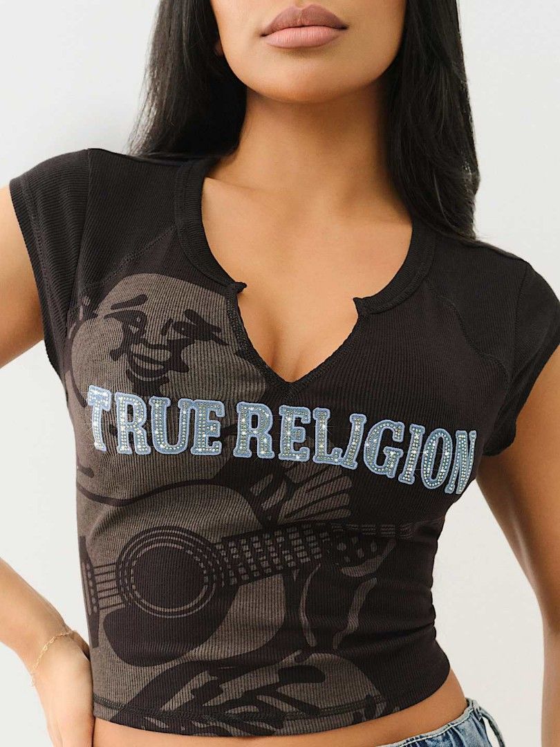 True Religion Crystal Buddha Notch Tee (Category: Sleeveless) located in Bayambang. Submitted by mon10192816 (Listing ID 1463751779, Image 1). Description: - Width 17 - Length 16 - True Religion cropped t-shirt - Features a Buddha and guitar graphic - Rhinestone details on 'True Religion' text - Notch neckline - Short sleeves - Material: Polyester, Rayon, Spandex blend - Perfect for a casual, edgy style.