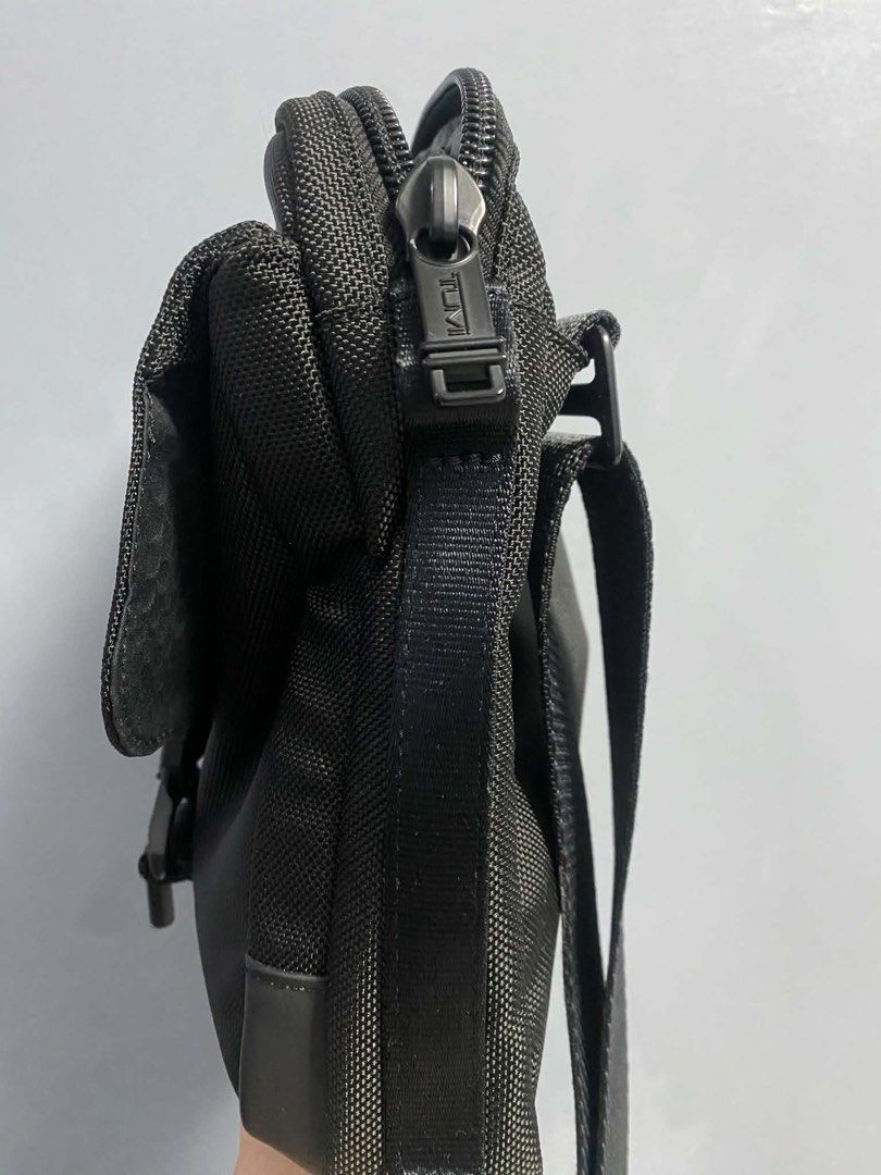 Tumi Black Nylon Crossbody Bag (Category: Sling Bags) located in San Juan City. Submitted by iam_phoenix (Listing ID 1463862699, Image 1). Description: Tumi Alpha Bravo Junior Crossbody Color: Black Dimensions: 7cm × 22cm × 24cm In almost brand new condition Interior: 2 card pockets Media open pocket Zip pocket Key leash Tumi tracer Pen holders Exterior: L-zip entry to main compartment L-zip front pocket Back slip pocket Adjustable shoulder strap