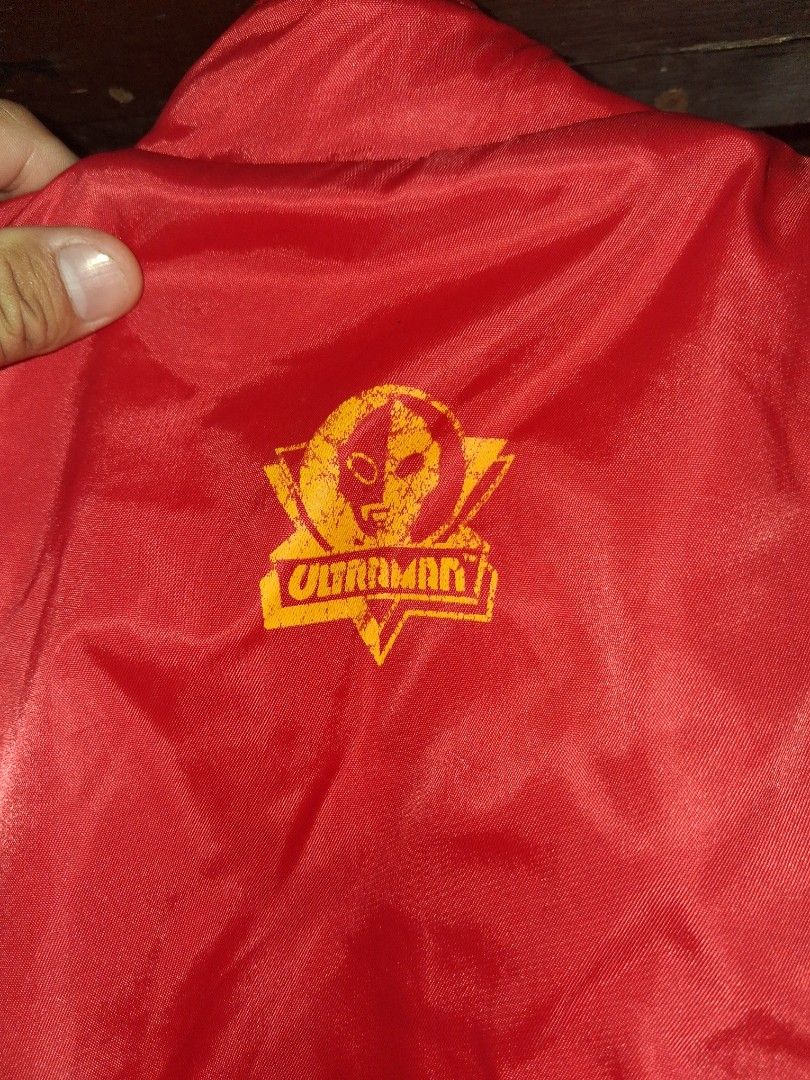 Ultraman Vest with Yellow Lining (Category: Vests) located in Manila. Submitted by marcas022798212 (Listing ID 1463753400, Image 2). Description: - Red vest with yellow lining - Two zippered front pockets - Brand logo on chest - Additional logo on side pocket - Size: 15x14 - Ideal for outdoor activities.