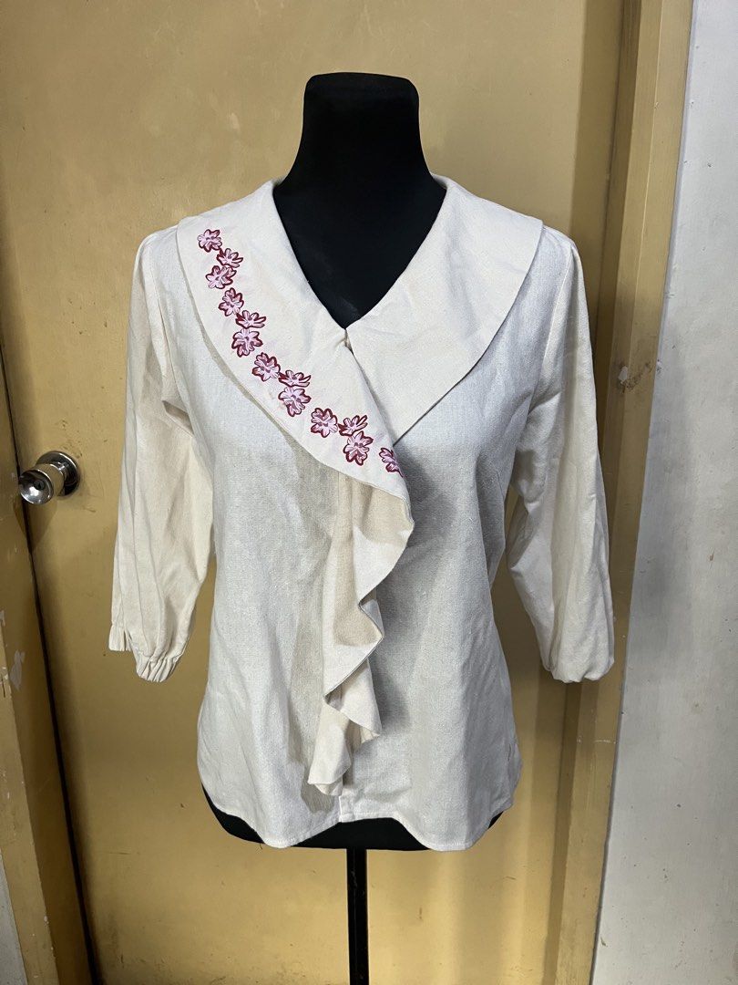 UNICA Cream Floral Design (Category: Blouses) located in Quezon City. Submitted by kikays0215 (Listing ID 1463802747, Image 2). Description: - Cream colored blouse from UNICA - Size: Medium (M) - Pretty floral embroidery along the collar - V-neck with ruffled front detail - 3/4 sleeves with elastic cuffs - Versatile: pairs well with jeans or skirts.