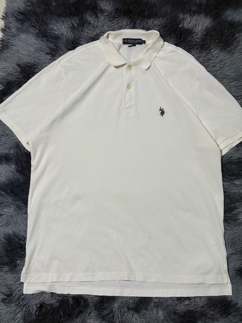 U.S. Polo Assn. White Polo Shirt (Category: Tshirts & Polo Shirts ) located in Bulacan. Submitted by luck_finds (Listing ID 1463866607, Image 1). Description: W: 21 L:30 - Classic white polo shirt from U.S. Polo Assn. - Features signature embroidered logo on the chest - Short sleeves with a two-button placket - Comfortable and versatile for casual wear - Easy to pair with jeans or shorts for everyday outfits.