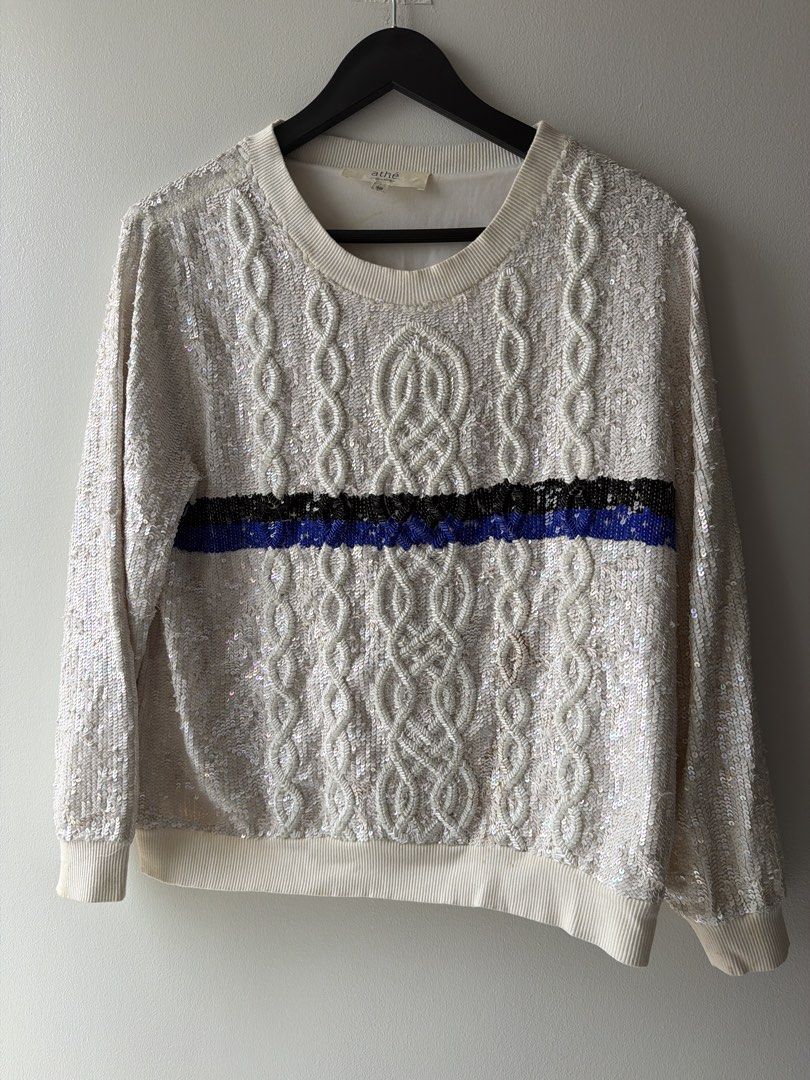 Vanessa Bruno Athe Cream Sequin Cable Knit Sweater (Category: Coats, Jackets and Outerwear) located in Makati City. Submitted by cheapipie (Listing ID 1463773268, Image 1). Description: - Cream cable knit sweater with eye-catching sequins. Retails for $320 - Features a stylish blue and black stripe detail across the chest. - Long sleeves with ribbed cuffs and hem for a comfortable fit. - Ideal for a night out or any festive occasion. - Approximat