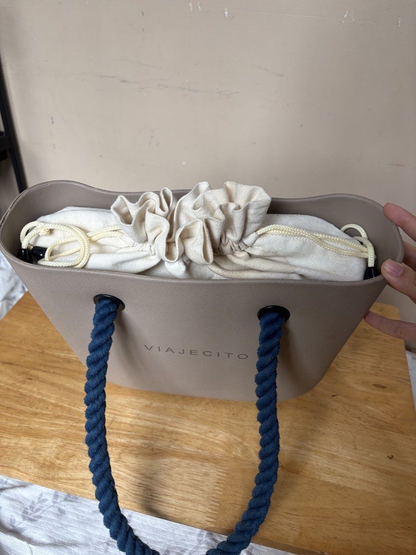 Viajecito Midi Beach Tote Set with Drawstring Inner (Category: Tote Bags) located in Imus. Submitted by kyla_declutters (Listing ID 1463774960, Image 2). Description: - Brand: Viajecito - Color: Taupe and Navy handles (this colourway is no longer available btw) - Handles: Sturdy navy rope - Interior: Comes with a cotton jute drawstring inner pouch - Features: Spacious, great for everyday use or beach trips! I love this so much. I hardly use this.