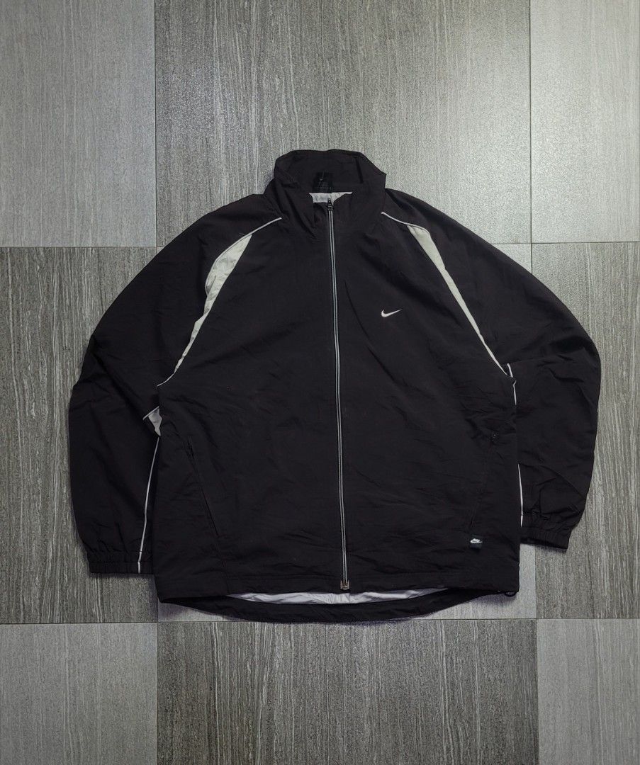 VINTAGE 2000s NIKE WINDBREAKER TRACK JACKET (Category: Hoodies) located in Manila. Submitted by 7100treasure.co (Listing ID 1463897264, Image 1). Description: VINTAGE 2000s NIKE WINDBREAKER TRACK JACKET ​• Brand: Nike • Style: Vintage 2000s Lightweight Windbreaker / Track Jacket • Color: Black / Grey / White • 100% Polyester outer shell & lining • Smooth interior lining • Embroidered mini Swoosh logo on left chest • Small Nike tab logo near lower