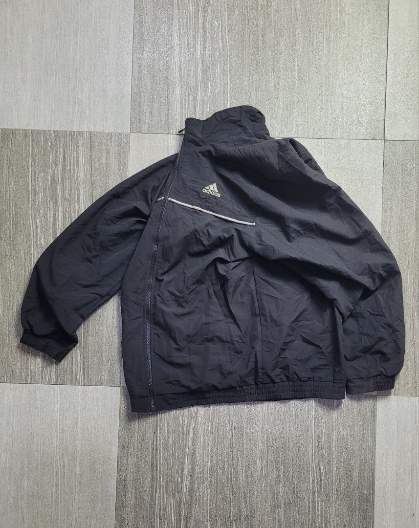 VINTAGE ADIDAS WINDBREAKER (Category: Hoodies) located in Manila. Submitted by 7100treasure.co (Listing ID 1463882777, Image 3). Description: VINTAGE ADIDAS WINDBREAKER • Style: Vintage Windbreaker • Color: Black • Breathable black mesh interior lining • Classic embroidered Adidas Performance logo • White piping design across the chest and back • Full-zip closure • Elastic cuffs and bottom hem • Width: 28" • Length: 22" ​📍 Dipolog City, Zamboang