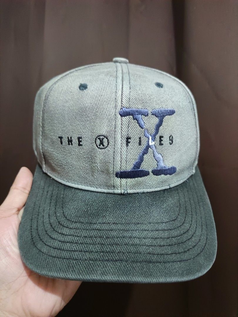 Vintage The X-Files Embroidered Baseball Cap (Category: Caps & Hats) located in Jaen. Submitted by ratbunizer (Listing ID 1463900156, Image 1). Description: - Grey and dark green baseball cap - Embroidered 'The X-Files' logo on the front - Adjustable strap for a comfortable fit - Perfect for X-Files fans.
