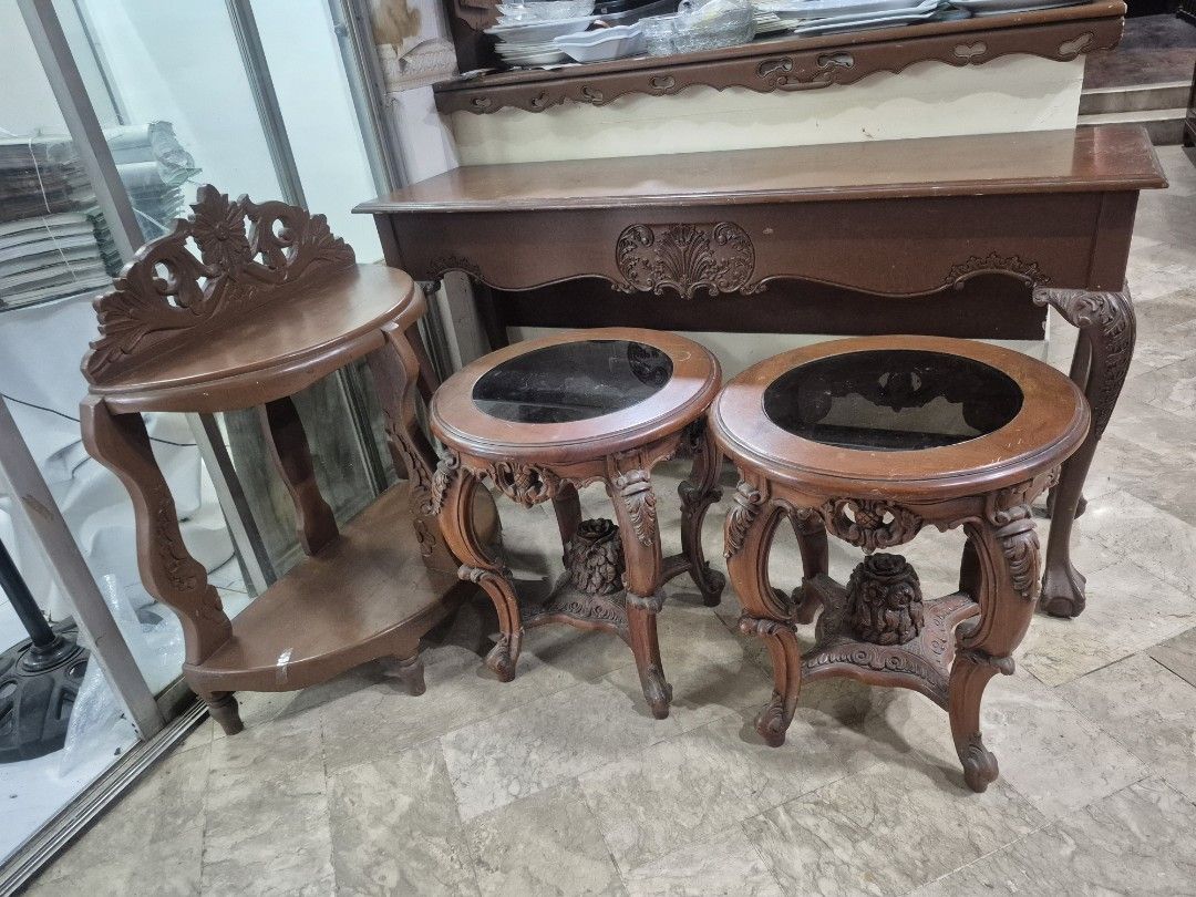 Vintage Wooden Console Table and Side Tables Set (Category: Tables & Sets) located in Taguig. Submitted by firesale123 (Listing ID 1463812376, Image 1). Description: - Vintage wooden furniture set - Includes: 1 long console table & 2 round side tables with glass tops - Features beautiful carved details on legs and edges - Console table has ornate front panel carvings - Side tables feature a floral motif - Ideal for classic or antique-themed decor