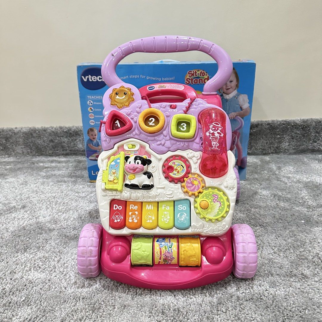 VTech Sit-to-Stand Learning Walker Pink (Category: Infant Playtime) located in Paranaque City. Submitted by changingclassic (Listing ID 1463926306, Image 1). Description: VTech Sit-to-Stand Learning Walker in Pink - Ideal for babies developing walking skills - Interactive features: piano keys, shape sorter, animal sounds - Detachable phone for independent play - Promotes development of motor skills and cognitive learning - Comes with original pac