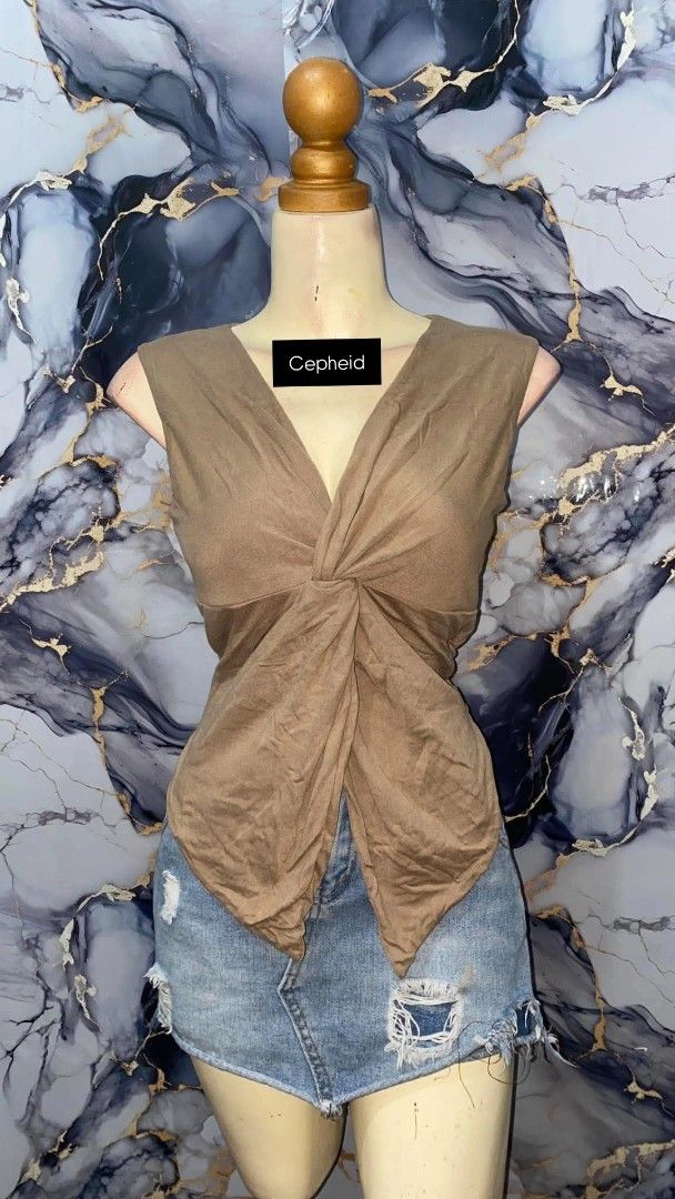 VXN Olivia Top Twist Front Sleeveless Top (Category: Sleeveless) located in Agdangan. Submitted by cepheid_regaspi (Listing ID 1463861560, Image 1). Description: -Can fit up to Large - Brown sleeveless top - Twist front detail - V-neckline - Asymmetrical hem - Versatile: pairs well with skirts or shorts - Suitable for casual outings or dressing up.