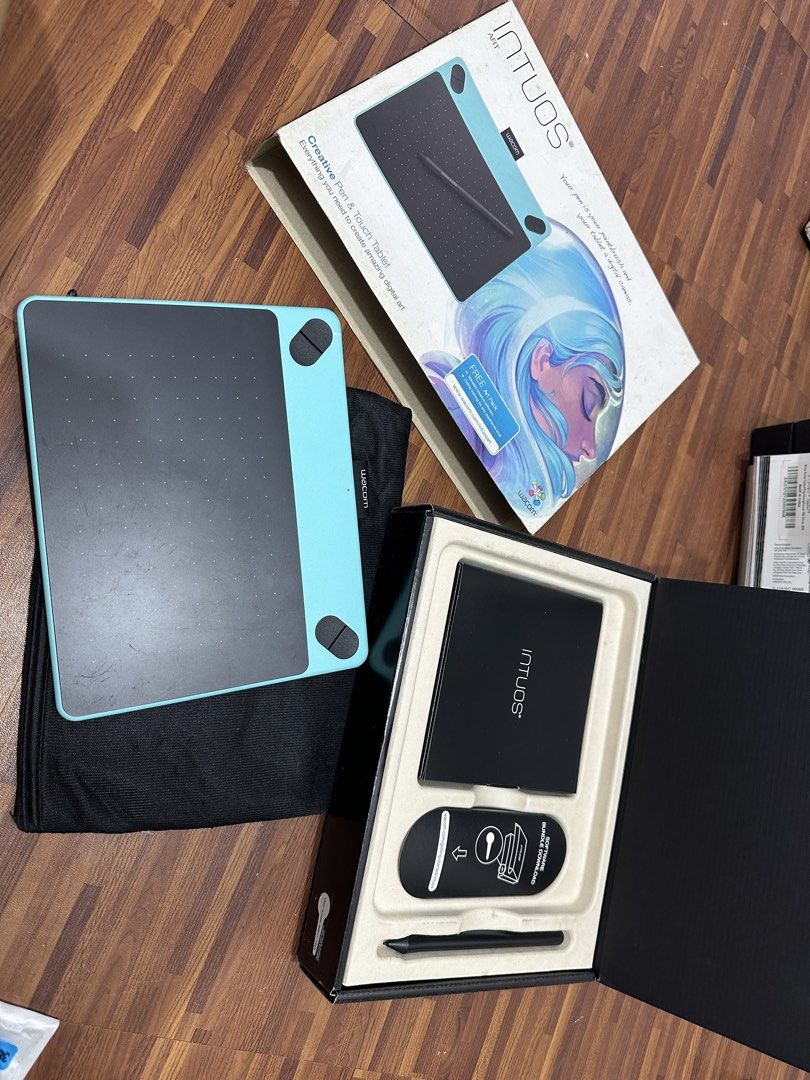 Wacom Intuos ART Creative Pen Tablet (Category: Laptops & Notebooks) located in Quezon City. Submitted by hellosydney78 (Listing ID 1463777247, Image 1). Description: - Wacom Intuos drawing tablet - Includes pen, USB cable, and original box - Features a teal frame and black drawing surface - Comes with a protective sleeve - Ideal for digital art and design projects - Complete inclusions.