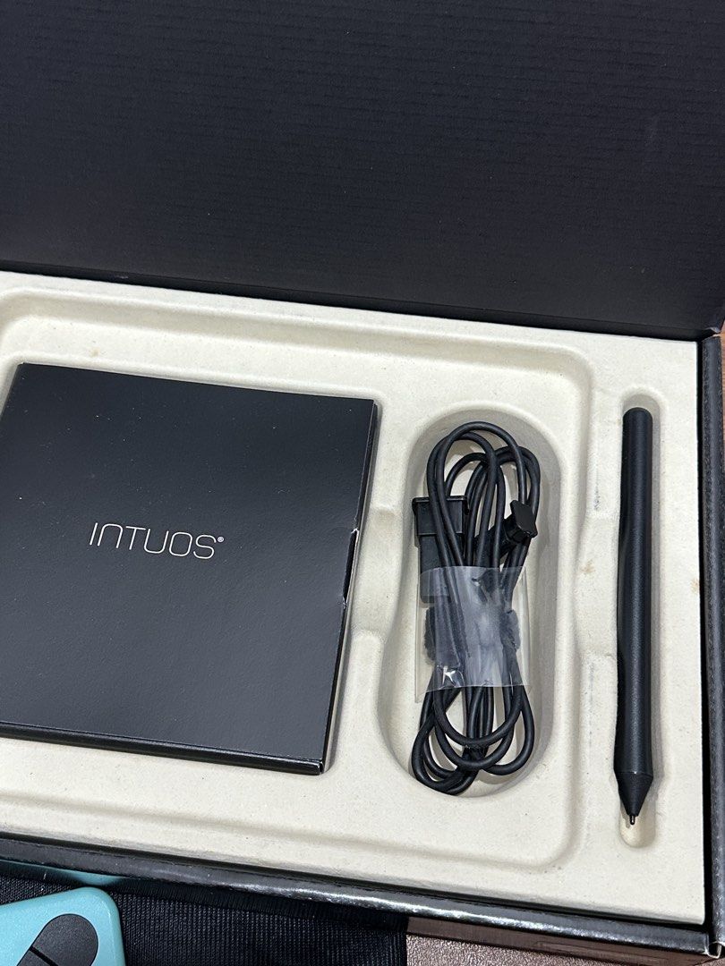 Wacom Intuos ART Creative Pen Tablet (Category: Laptops & Notebooks) located in Quezon City. Submitted by hellosydney78 (Listing ID 1463777247, Image 3). Description: - Wacom Intuos drawing tablet - Includes pen, USB cable, and original box - Features a teal frame and black drawing surface - Comes with a protective sleeve - Ideal for digital art and design projects - Complete inclusions.