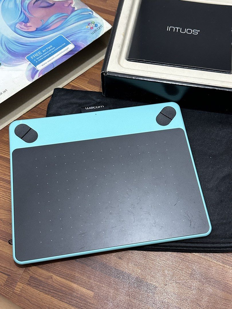 Wacom Intuos ART Creative Pen Tablet (Category: Laptops & Notebooks) located in Quezon City. Submitted by hellosydney78 (Listing ID 1463777247, Image 2). Description: - Wacom Intuos drawing tablet - Includes pen, USB cable, and original box - Features a teal frame and black drawing surface - Comes with a protective sleeve - Ideal for digital art and design projects - Complete inclusions.