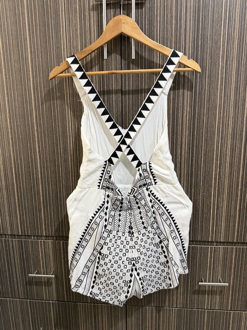 White & Black Geometric Print Romper with Criss-Cross Back (Category: Rompers) located in Manila. Submitted by maiserdaz (Listing ID 1463808015, Image 2). Description: - White romper with bold black geometric print - V-neckline - Criss-cross straps at the back - Ties with a bow at the back - Lightweight fabric - Ideal for beach days or casual outings - Fun tribal-inspired pattern.