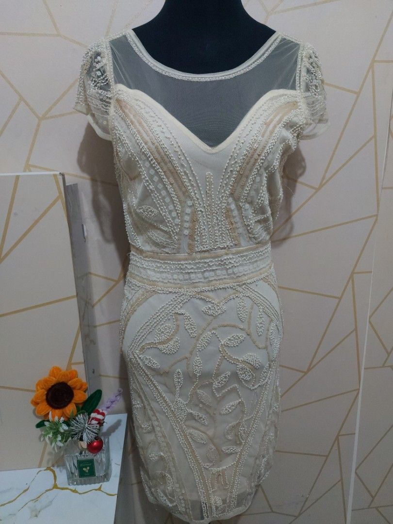White Beaded Sheer Sleeve Mini Dress (Medium) (Category: Dresses) located in Manila. Submitted by jollyann_b1990 (Listing ID 1463848682, Image 1). Description: - Elegant white mini dress - Intricate all-over beading - Sheer sleeves with beaded details - Zipper closure at the back - Flattering fitted silhouette - Ideal for parties and special occasions - Unique and eye-catching design.