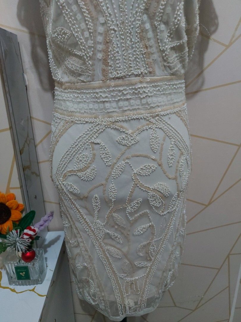 White Beaded Sheer Sleeve Mini Dress (Medium) (Category: Dresses) located in Manila. Submitted by jollyann_b1990 (Listing ID 1463848682, Image 3). Description: - Elegant white mini dress - Intricate all-over beading - Sheer sleeves with beaded details - Zipper closure at the back - Flattering fitted silhouette - Ideal for parties and special occasions - Unique and eye-catching design.