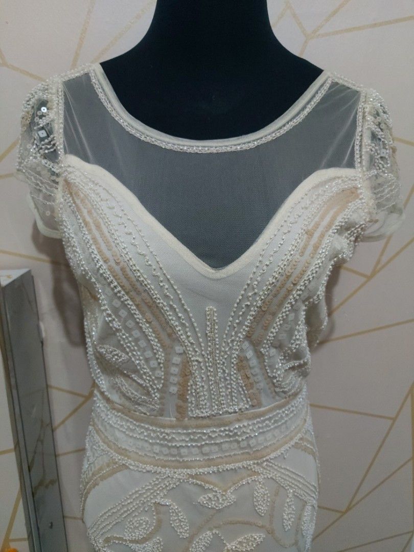 White Beaded Sheer Sleeve Mini Dress (Medium) (Category: Dresses) located in Manila. Submitted by jollyann_b1990 (Listing ID 1463848682, Image 2). Description: - Elegant white mini dress - Intricate all-over beading - Sheer sleeves with beaded details - Zipper closure at the back - Flattering fitted silhouette - Ideal for parties and special occasions - Unique and eye-catching design.