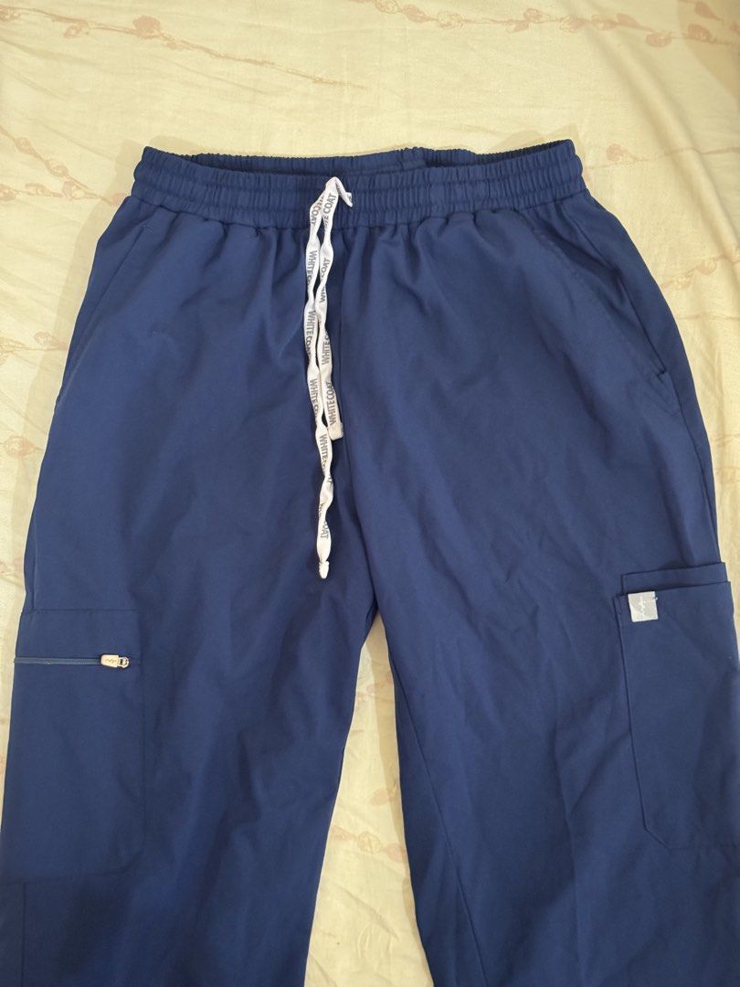 White Coat Navy Blue Scrub Pants (Category: Sets or Coordinates) located in Makati City. Submitted by fifoaway (Listing ID 1463762982, Image 1). Description: - Navy blue scrub pants from White Coat - Comfortable elastic waistband with drawstring - Multiple pockets, including a secure side zipper pocket - Durable and easy-care fabric - Perfect for work or casual wear.