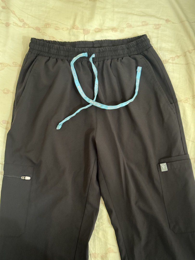 White Coat Scrub Pants Black Drawstring Cargo Pockets (Category: Sets or Coordinates) located in Makati City. Submitted by fifoaway (Listing ID 1463762899, Image 1). Description: - Black scrub pants from White Coat - Elastic waistband with light blue drawstring - Multiple cargo pockets, one with zipper closure - White Coat logo on drawstring and pocket tag - Comfortable and practical for work.