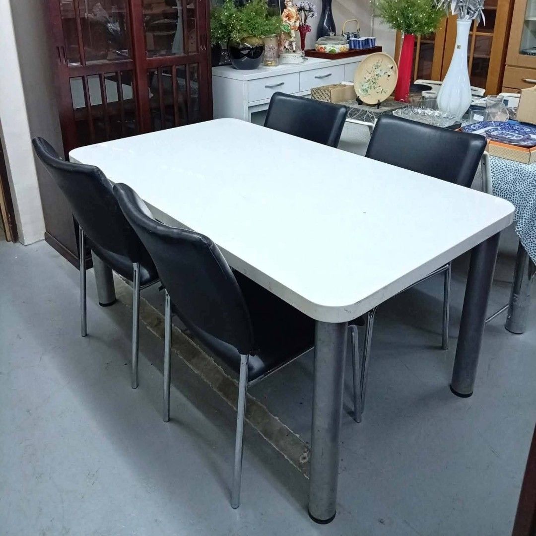 White Dining Table with 4 Black Chairs (Category: Tables & Sets) located in Manila. Submitted by japan.korea.surplus (Listing ID 1463836007, Image 1). Description: - White dining table with smooth top - Sturdy metal legs for table and chairs - Includes 4 upholstered black chairs - Ideal for small to medium dining areas - Ready for its new home!.