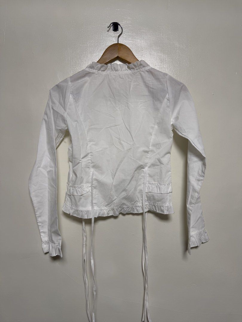 White Long Sleeve Ruffle Front Blouse (Category: Blouses) located in Manila. Submitted by don_p (Listing ID 1463866376, Image 2). Description: S to M - Elegant white long sleeve blouse - Features delicate ruffle detailing down the front - Full button-up closure at the center - Adjustable tie at the bottom hem for a customized fit - Ruffled cuffs add a touch of flair - Versatile piece: dress it up or down!.