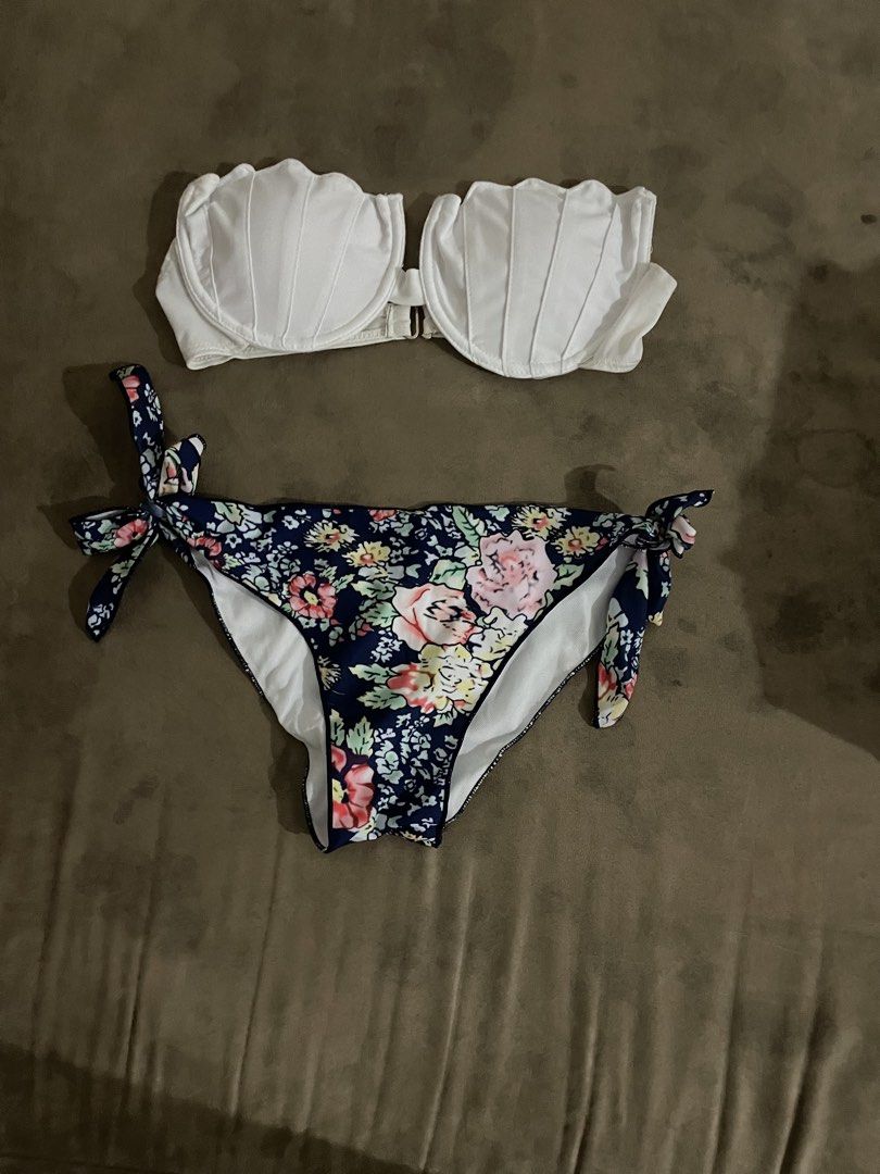 White Shell Bikini Top & Floral Bikini Bottoms (Category: Bikinis & Swimsuits) located in Antipolo. Submitted by chicgrc (Listing ID 1463776538, Image 1). Description: 📍marikina / antipolo city 🚚 lalamove 💵 gcash / maya / gotyme - White strapless bikini top with unique shell-like cups. - Matching bottoms feature a navy blue floral print. - Adjustable tie sides on the bottoms for a custom fit. - Ideal for beach days, pool parties, or your next 