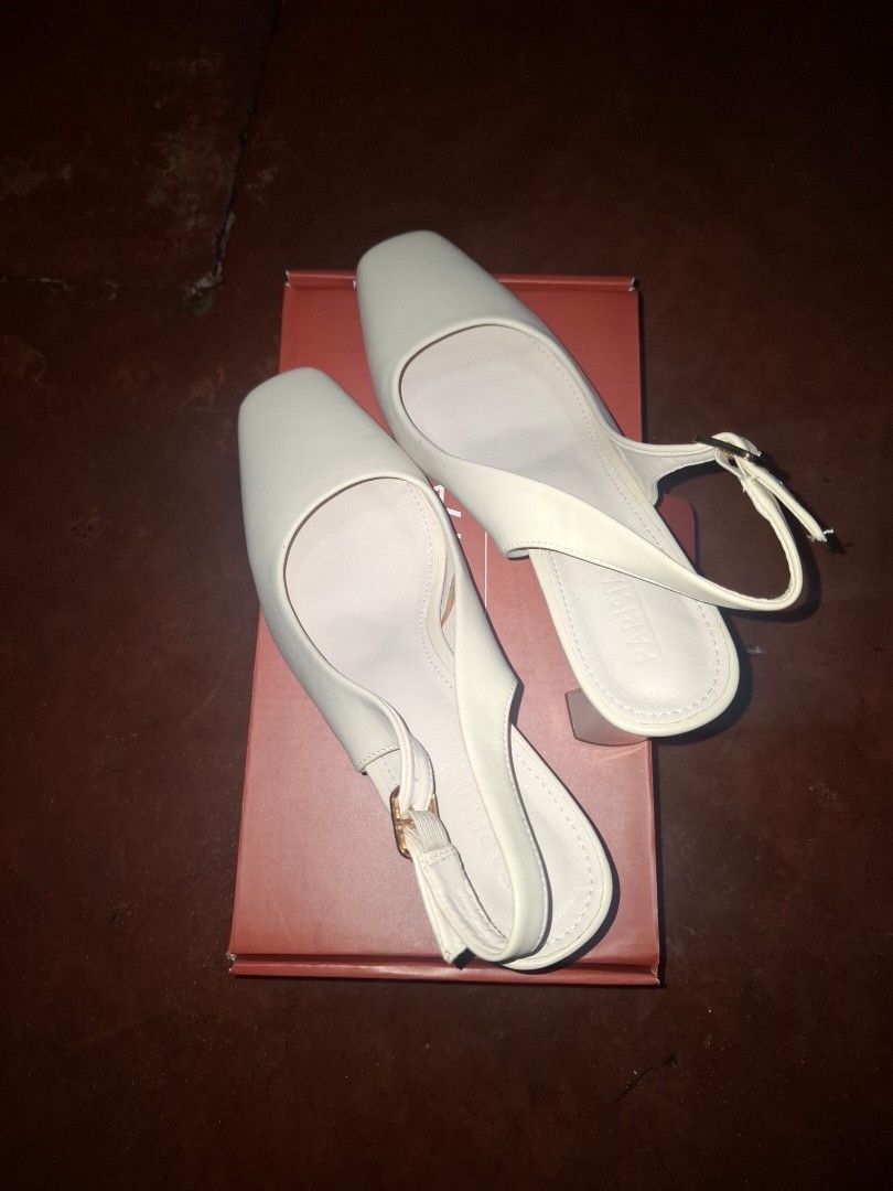 White Slingback Square Toe Heels Size 41 (Category: Heels) located in Caloocan City. Submitted by mariatheresa1994 (Listing ID 1463937366, Image 1). Description: White slingback heels, size 41. Features a square toe, block heel, and ankle buckle strap. Like new, comes with original box. Versatile for any outfit..