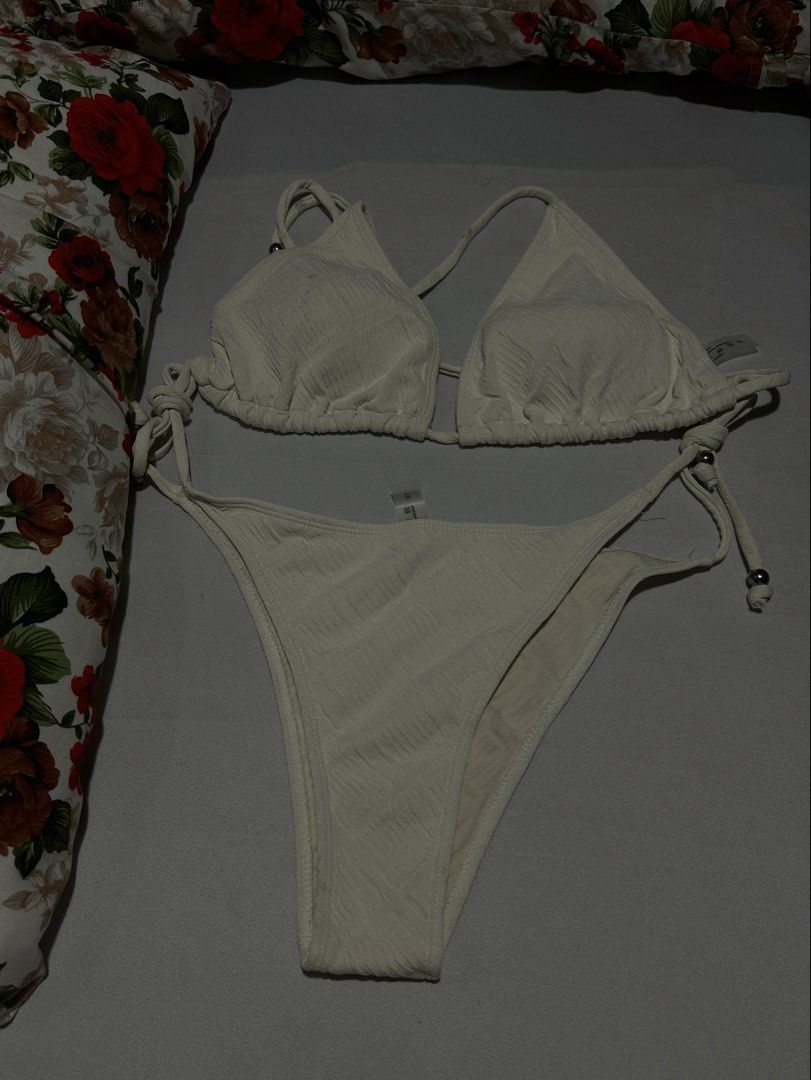 White Textured Triangle Bikini Set (Category: Bikinis & Swimsuits) located in Manila. Submitted by erikaerika05 (Listing ID 1463890521, Image 1). Description: Simple, cute & flattering bikini set White/cream textured fabric 🎀 Adjustable tie straps on the top and bottom Lightly used — worn only once 📏 Best fit for up to 5’2” height (M-L) 🫧 May have minimal washable stains from use/storage 📸 Photo note: Actual color may slightly vary from the p