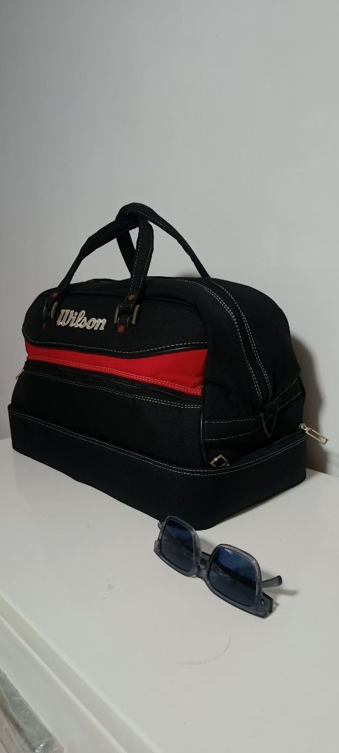 Wilson Duffel Bag Tennis (Category: Backpacks) located in Paranaque City. Submitted by yesyesyo (Listing ID 1463816488, Image 2). Description: - Classic Wilson duffel bag - Color: Black with red accent stripe - Features sturdy handles and a zippered compartment - Ideal for gym sessions or travel - Spacious interior - used with care - lots of compartment this is not thrifted. all are for personal decluttering only. payment thru Gcash delivery opti