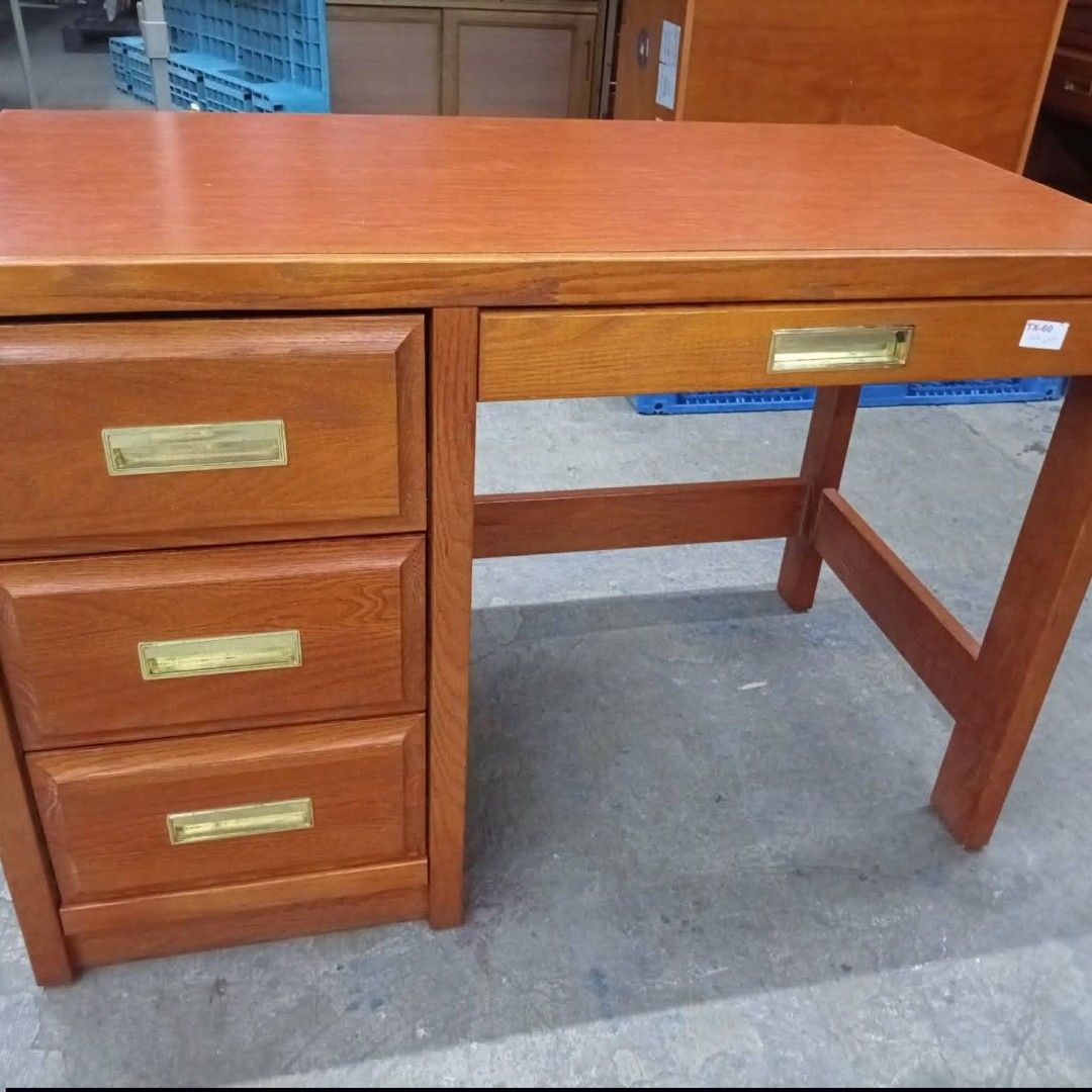 Wooden Desk with Drawers (Category: Office Furniture & Fixtures) located in Manila. Submitted by japan.korea.surplus (Listing ID 1463831158, Image 1). Description: - Solid wood desk - Warm wood tone - 4 drawers total - 3 drawers on the left side - 1 drawer on the right side - All drawers feature brass handles - Ideal for home office or study space.
