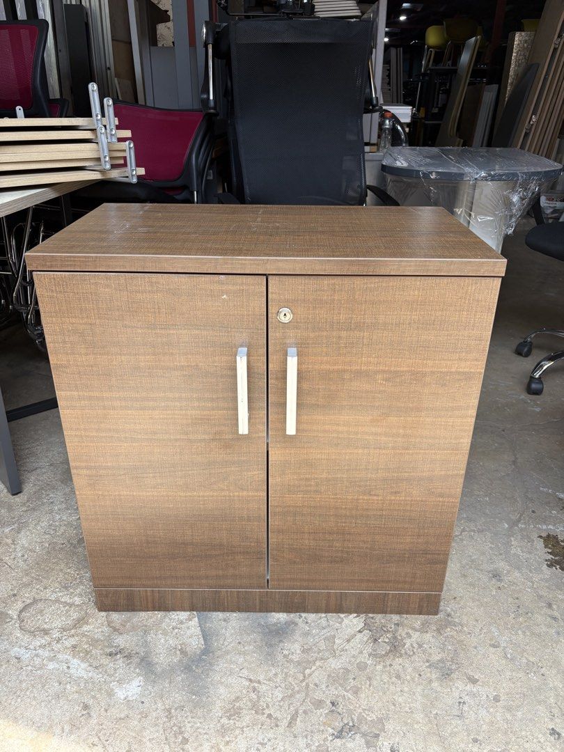 Wooden Two-Door Cabinet with Lock (Category: Shelves, Cabinets & Racks) located in Valenzuela. Submitted by cha_leng.861 (Listing ID 1463823124, Image 1). Description: - Brown wooden cabinet - Two doors with lock and two handles - Two shelves inside for ample storage - Approximate dimensions: 2 feet tall x 2 feet wide - Perfect for home or office organization.