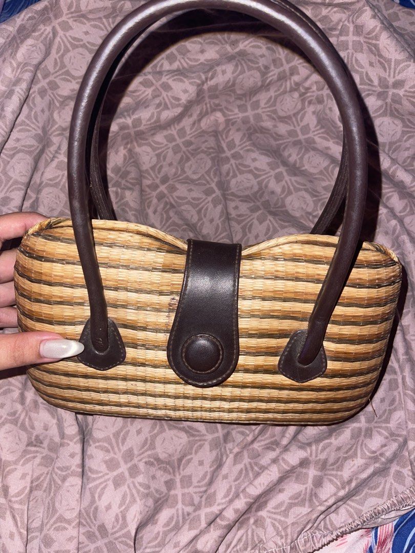 Woven Straw Handbag with Leather Handles (Category: Beach Bags) located in Manila. Submitted by fastforest_65f95b (Listing ID 1463777447, Image 2). Description: - Cute woven straw handbag - Features brown leather handles - Matching leather closure with button snap - Brown fabric lining - Interior pocket - Striped pattern in shades of brown and beige - Ideal size for everyday essentials.