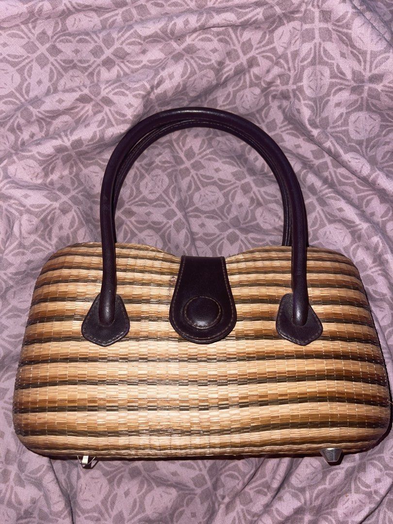 Woven Straw Handbag with Leather Handles (Category: Beach Bags) located in Manila. Submitted by fastforest_65f95b (Listing ID 1463777447, Image 1). Description: - Cute woven straw handbag - Features brown leather handles - Matching leather closure with button snap - Brown fabric lining - Interior pocket - Striped pattern in shades of brown and beige - Ideal size for everyday essentials.