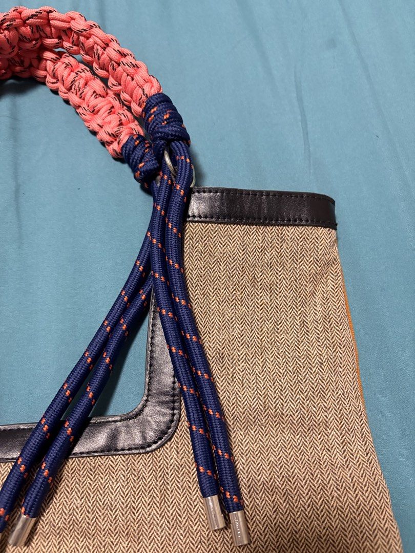 Woven Tote Bag with Rope Handles (Category: Tote Bags) located in Mandaluyong City. Submitted by sarisaringtinda (Listing ID 1463864436, Image 2). Description: - Unique woven tote bag - Braided rope handle in pink and navy blue - Tan herringbone weave body - Bright orange corduroy back - Black trim around top opening - Ideal for everyday use or beach trips.