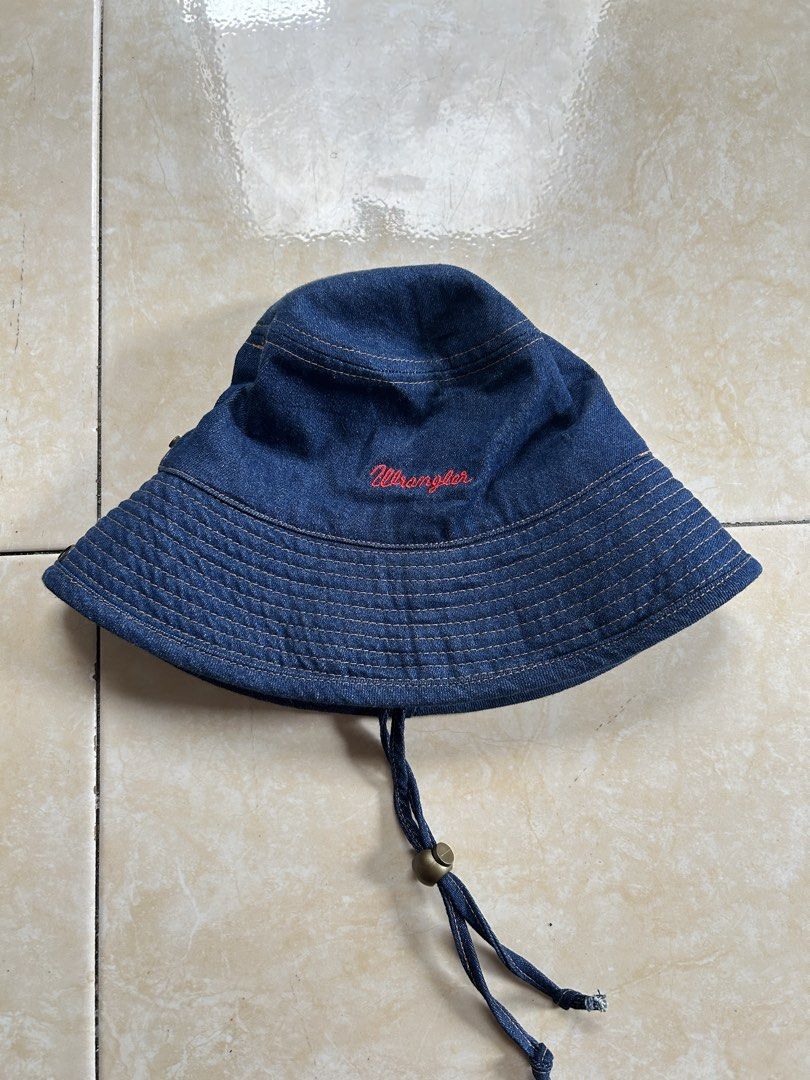 Wrangler Denim Bucket Hat (FREE SHIP) (Category: Hats & Beanies) located in General Santos City (Dadiangas). Submitted by moana_thrifts (Listing ID 1463799054, Image 1). Description: - Classic blue denim bucket hat from Wrangler - Features embroidered Wrangler logo on the front - Adjustable chin strap with toggles for a secure fit - Ideal for sunny outdoor adventures - Simple, stylish, and versatile.