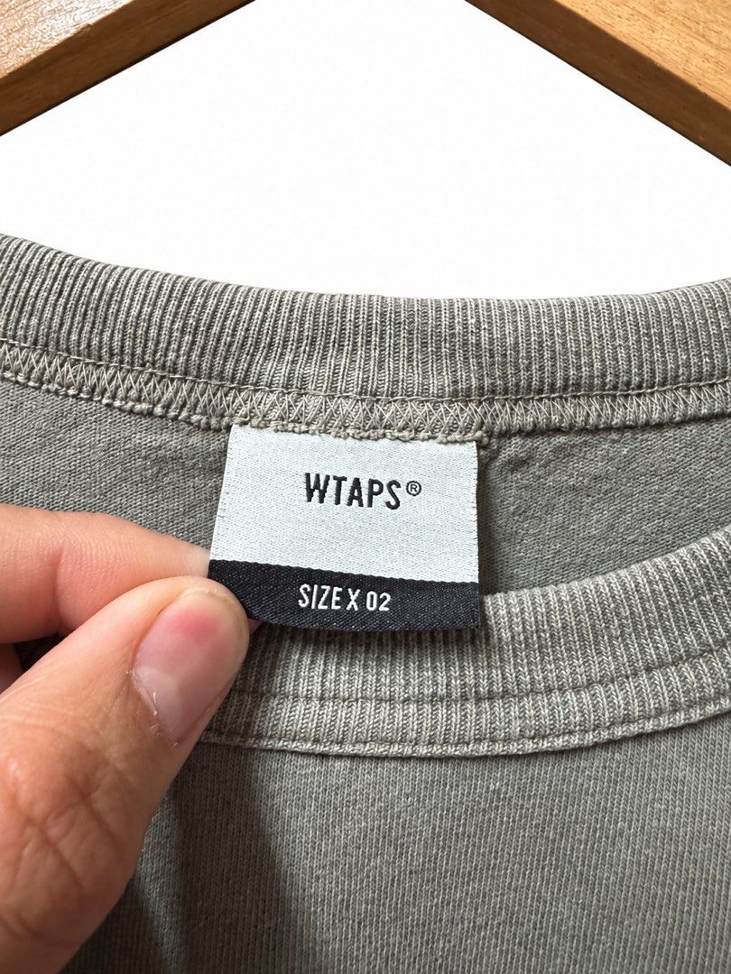WTAPS Visual Uparmored Crewneck Sweatshirt (Category: Coats, Jackets and Outerwear) located in Tangub. Submitted by laurbepena33002 (Listing ID 1463888769, Image 3). Description: - WTAPS crewneck sweatshirt - Color: Grey - Size: 02 -dimension: W22xL27xSL25 - Features 'WTAPS' and 'WT-VISUAL UPARMORED' print on the back - Tag indicates 'EX35 COLLECTION' - Made in Japan - Ideal for casual outfits.