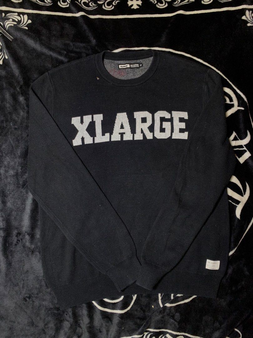 XLARGE Black Knit Sweater (Category: Longsleeves) located in Iloilo. Submitted by johnpullan30303 (Listing ID 1463868705, Image 1). Description: - Brand: XLARGE - Color: Black - Material: Knit sweater - Design: Signature XLARGE logo across the chest in contrasting knit - Features: Ribbed cuffs and hem - Occasion: Casual wear - Sizing: Check tag for details.