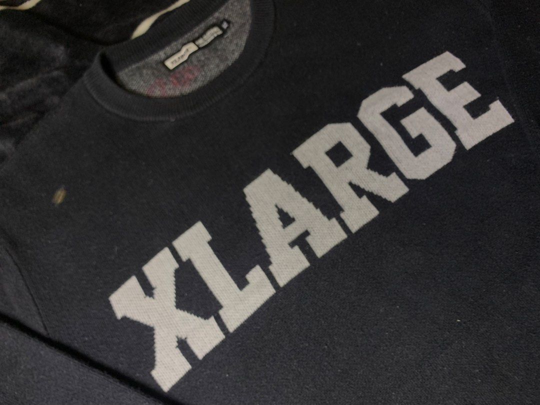 XLARGE Black Knit Sweater (Category: Longsleeves) located in Iloilo. Submitted by johnpullan30303 (Listing ID 1463868705, Image 3). Description: - Brand: XLARGE - Color: Black - Material: Knit sweater - Design: Signature XLARGE logo across the chest in contrasting knit - Features: Ribbed cuffs and hem - Occasion: Casual wear - Sizing: Check tag for details.