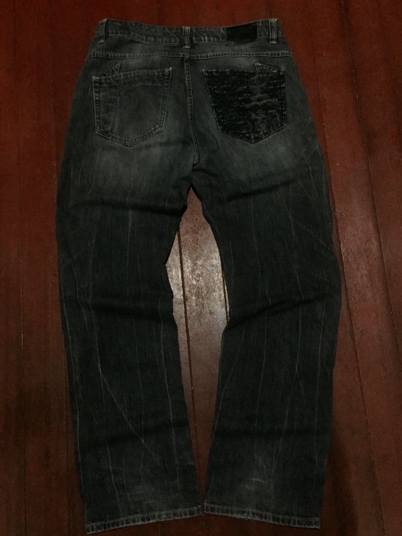 Y2K Osaka Big Train Denim Jeans (Category: Jeans) located in Manila. Submitted by carlosrexc26753 (Listing ID 1463921527, Image 2). Description: WAISTLINE: 34-35 LENGTH: 43.5 - Dark wash denim jeans - Straight leg fit - Unique textured detail on back right pocket - Button fly closure - Subtle distressing and fading throughout - Ideal for casual wear.