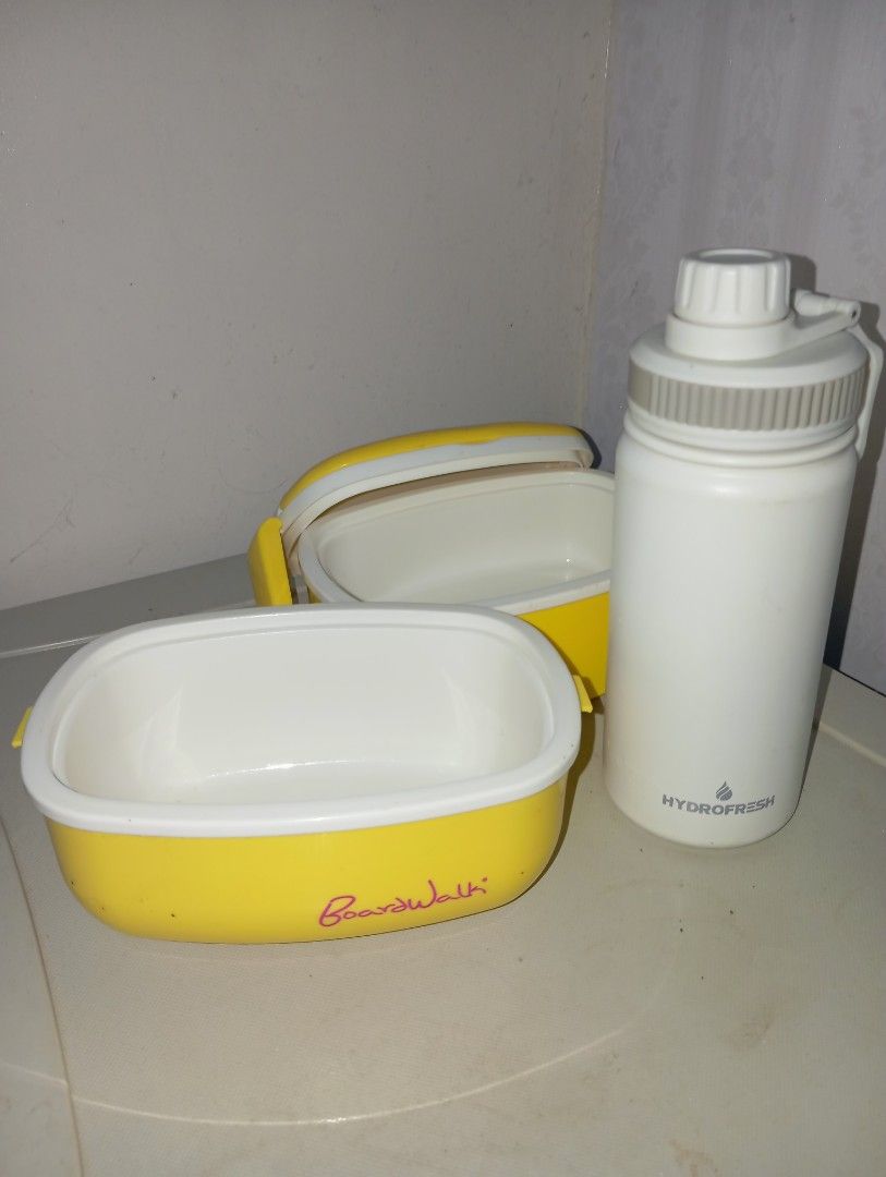 Yellow Boardwalk Lunch Box & Hydrofresh Water Bottle (Category: Food Organization & Storage) located in Dasmarinas. Submitted by kei05 (Listing ID 1463870249, Image 2). Description: - Yellow stackable lunch box with 'Boardwalk' branding - Two-tier design for ample food storage - White Hydrofresh water bottle included - Water bottle features a built-in filter - Ideal for packed lunches and staying hydrated - Both items are clean and ready for imme