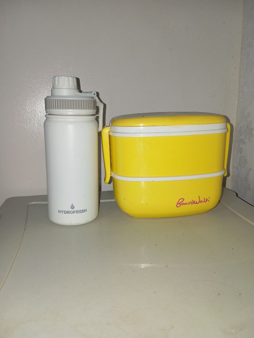 Yellow Boardwalk Lunch Box & Hydrofresh Water Bottle (Category: Food Organization & Storage) located in Dasmarinas. Submitted by kei05 (Listing ID 1463870249, Image 1). Description: - Yellow stackable lunch box with 'Boardwalk' branding - Two-tier design for ample food storage - White Hydrofresh water bottle included - Water bottle features a built-in filter - Ideal for packed lunches and staying hydrated - Both items are clean and ready for imme
