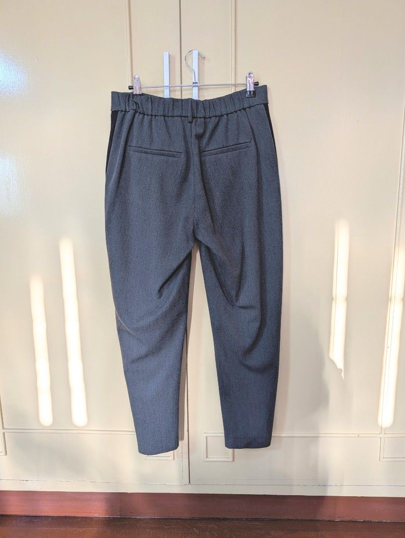 ZARA Trafaluc Collection Grey Trousers (Category: Other Bottoms) located in Santa Maria. Submitted by bax19 (Listing ID 1463935835, Image 2). Description: - Zara Trafaluc grey trousers - Cropped length - Elasticated waistband at the back for comfort - Side pockets - Black stripe detail down each leg - Perfect for casual or smart casual outfits.