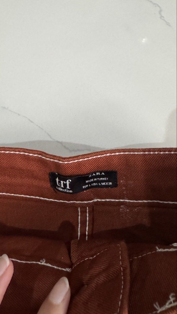 Zara TRF Burnt Orange Mini Skirt (Category: Skirts) located in Manila. Submitted by patc20 (Listing ID 1463809981, Image 2). Description: - Brown corduroy mini skirt from Zara TRF - Features contrast white stitching - Two front pockets.