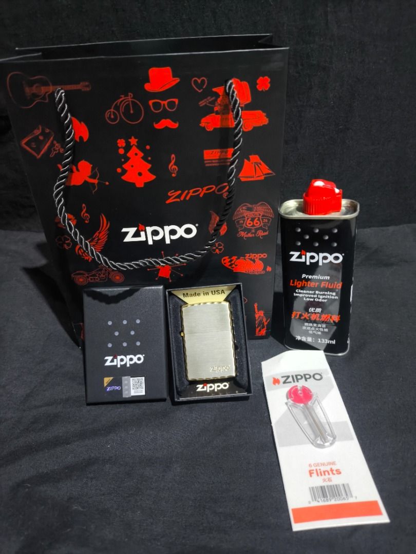 Zippo Lighter with Fluid and Flints - Made in USA (Category: Vintage Collectibles) located in Manila. Submitted by weyvern28 (Listing ID 1463840040, Image 3). Description: - Brand new Zippo lighter, Gold plated. never used. - Comes in its original Zippo box. - Includes a can of premium lighter fluid. - Includes a pack of replacement flints. - Features a classic brushed metal finish. - Textured edges for a secure grip. - Authentic Zippo, Made in t