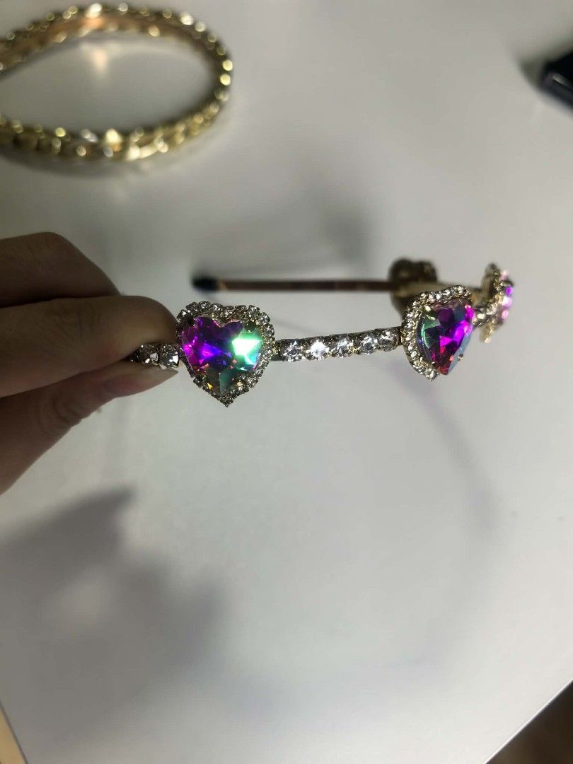 2forP150 Gold Chain & Heart Gem Headbands Set (Category: Hair Accessories) located in Manila. Submitted by aquarianworld (Listing ID 1463967200, Image 2). Description: - Set of two cute gold-toned headbands. - Headband 1: Features a stylish chunky gold chain design. - Headband 2: Adorned with sparkly rhinestones and colorful heart gems. - Instantly adds flair to any outfit. - Ideal for parties, special occasions, or casual dressing up..